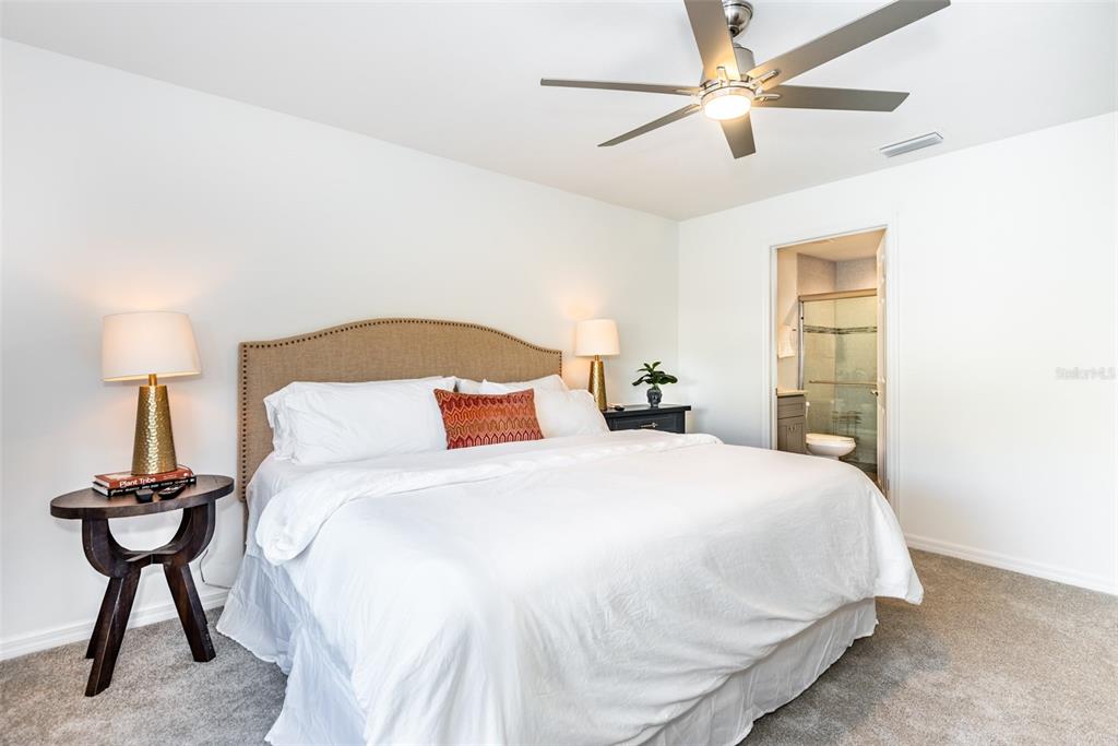 219 Lewis Circle, Unit 112 Punta Gorda, FL 33950 - Photo 25 of 36 a bedroom with a bed and a table lamp