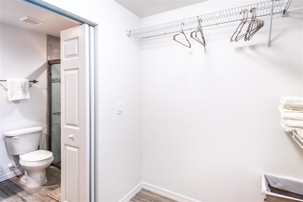 219 Lewis Circle, Unit 112 Punta Gorda, FL 33950 - Photo 30 of 36 a bathroom with a granite countertop shower a toilet and a shower