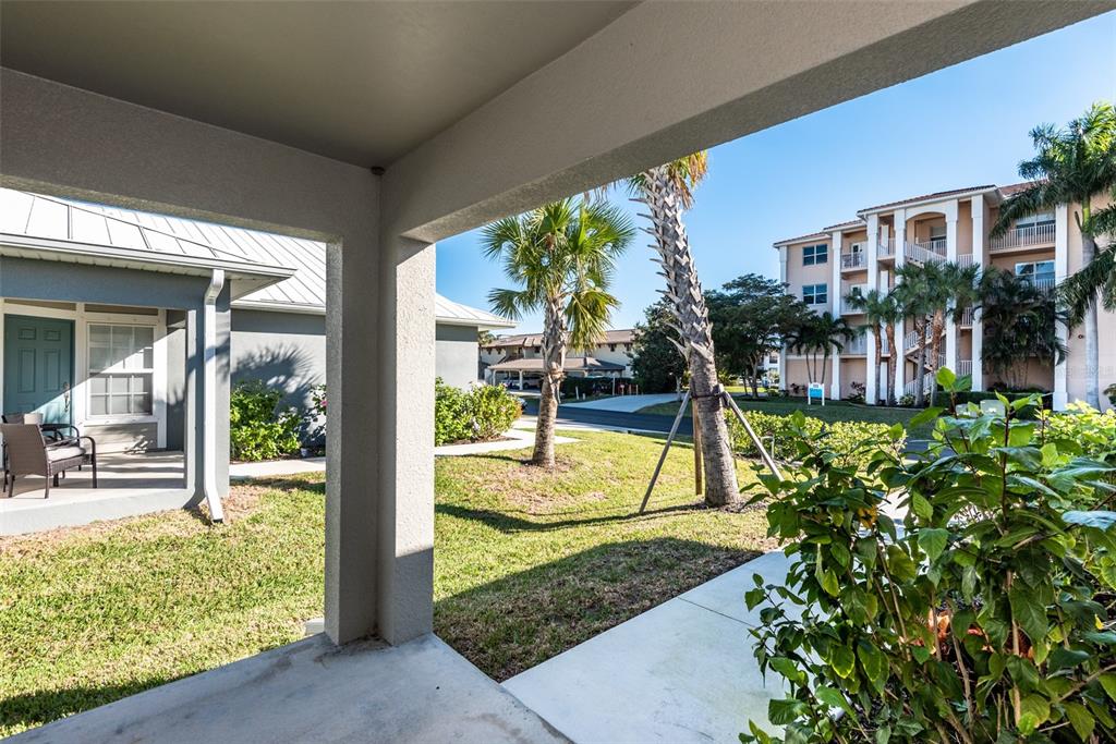 219 Lewis Circle, Unit 112 Punta Gorda, FL 33950 - Photo 3 of 36 a view of a swimming pool with a bench and floor to ceiling window