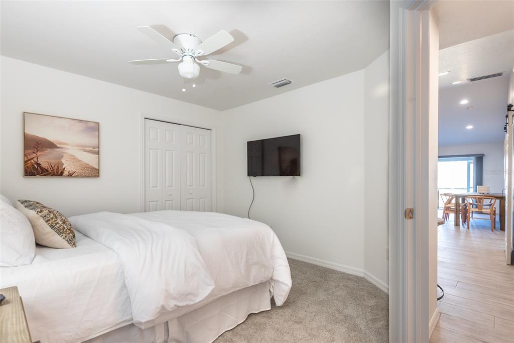 219 Lewis Circle, Unit 112 Punta Gorda, FL 33950 - Photo 36 of 36 a bedroom with a bed and a flat screen tv