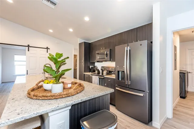 a kitchen with refrigerator and a sink