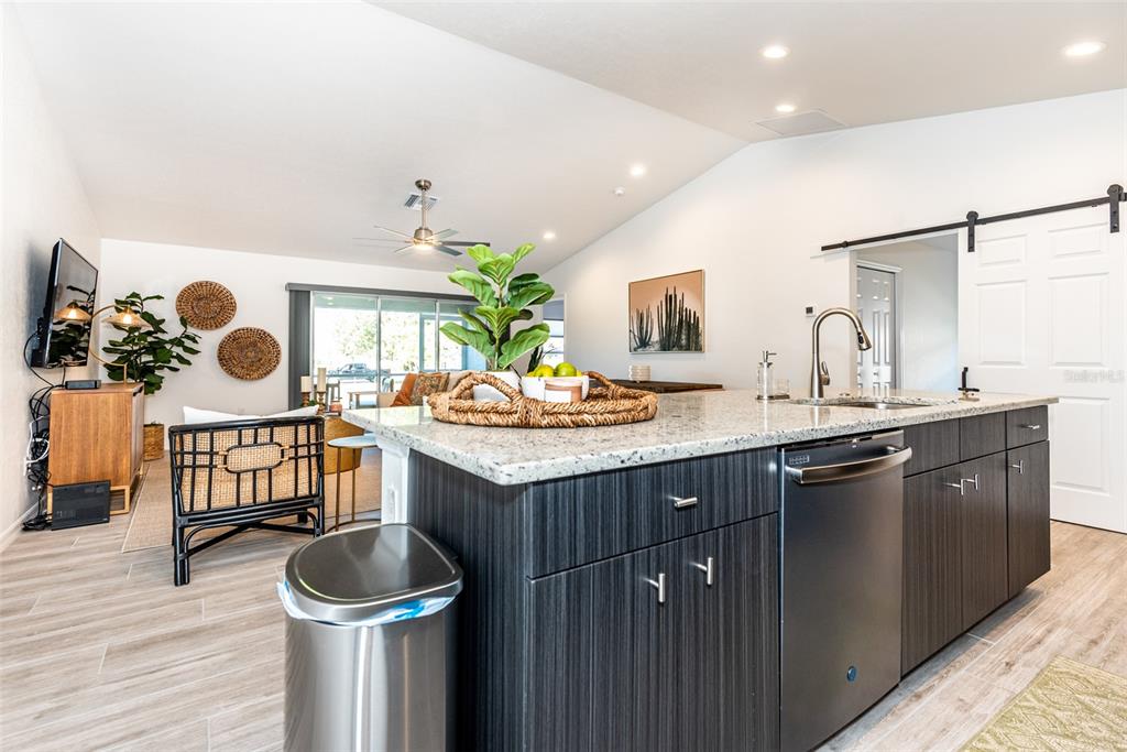 219 Lewis Circle, Unit 112 Punta Gorda, FL 33950 - Photo 7 of 36 a kitchen with a sink and a stove with wooden floor