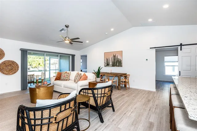 a living room with furniture a wooden floor and a window