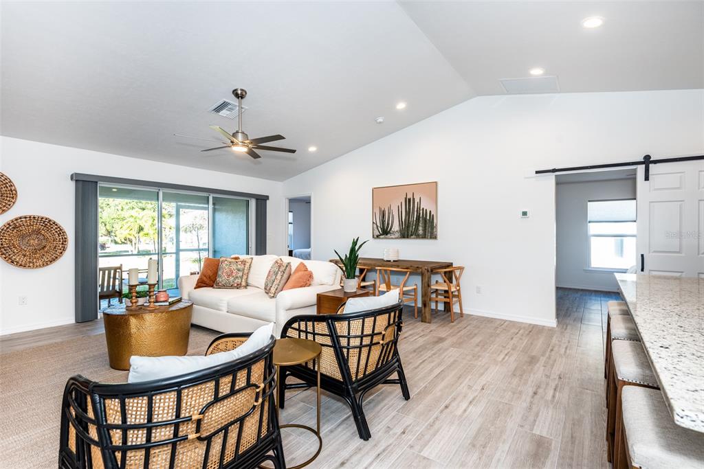 219 Lewis Circle, Unit 112 Punta Gorda, FL 33950 - Photo 9 of 36 a living room with furniture a wooden floor and a window