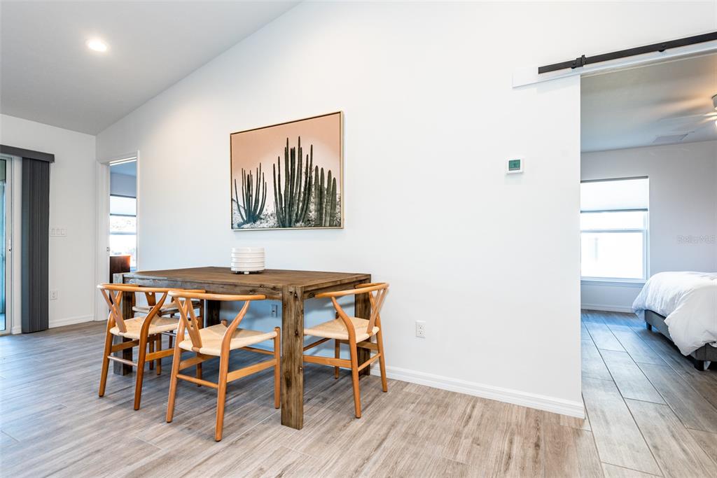 219 Lewis Circle, Unit 112 Punta Gorda, FL 33950 - Photo 10 of 36 a dining room with furniture and wooden floor