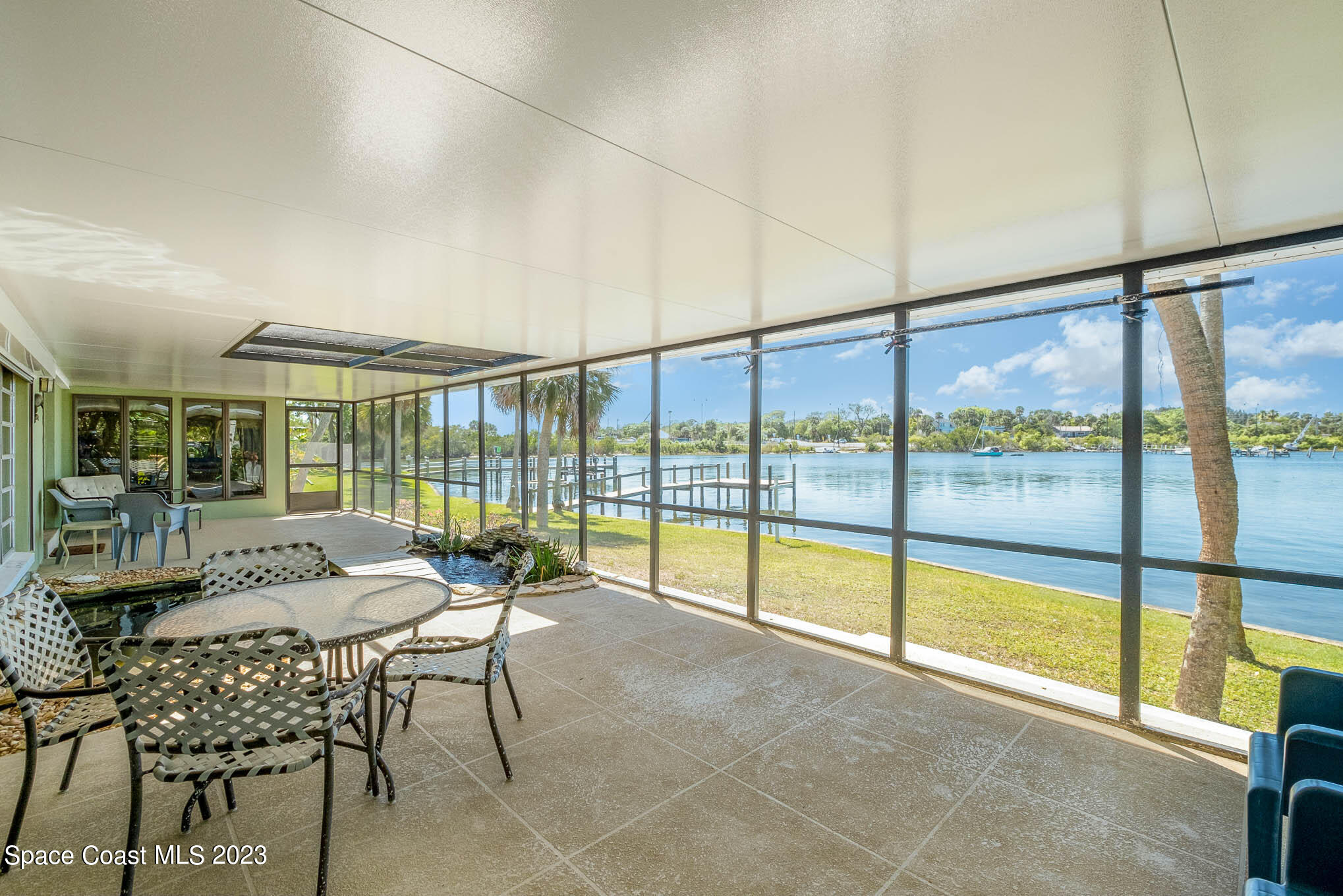 1466 Herndon Circle Palm Bay, FL 32905 - Photo 12 of 23 a living room with furniture and floor to ceiling windows