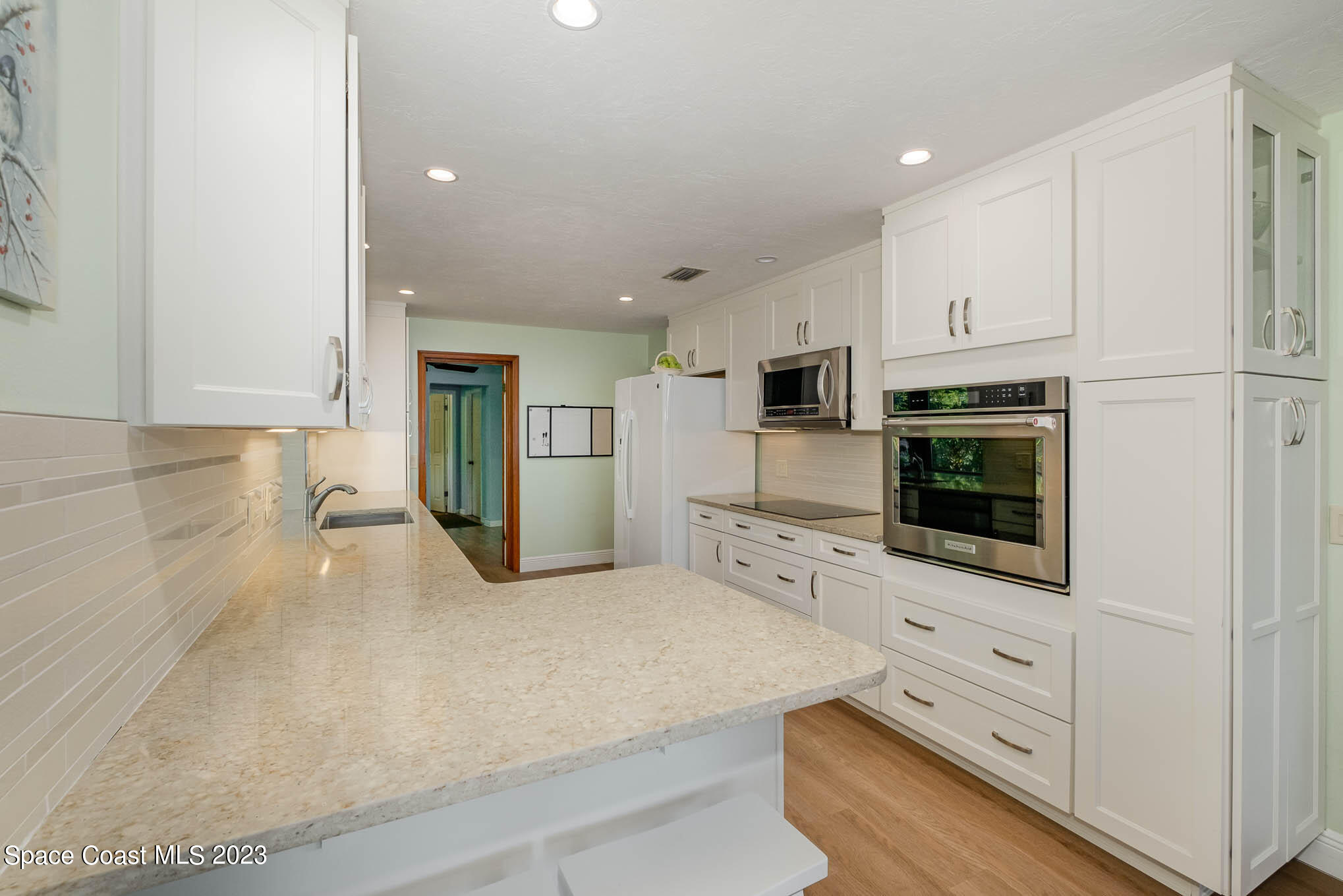 1466 Herndon Circle Palm Bay, FL 32905 - Photo 16 of 23 a kitchen with stainless steel appliances a refrigerator stove and microwave