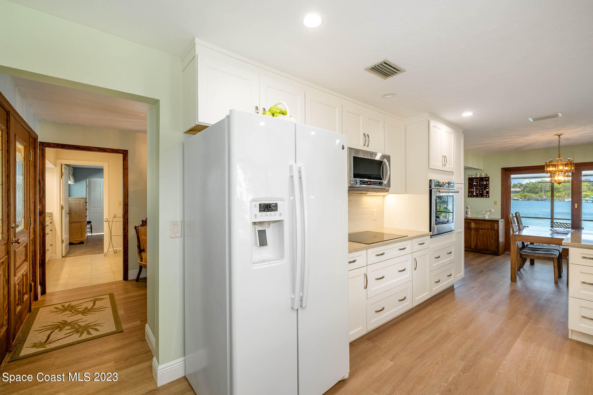 1466 Herndon Circle Palm Bay, FL 32905 - Photo 18 of 23 a kitchen with granite countertop a refrigerator and a stove top oven