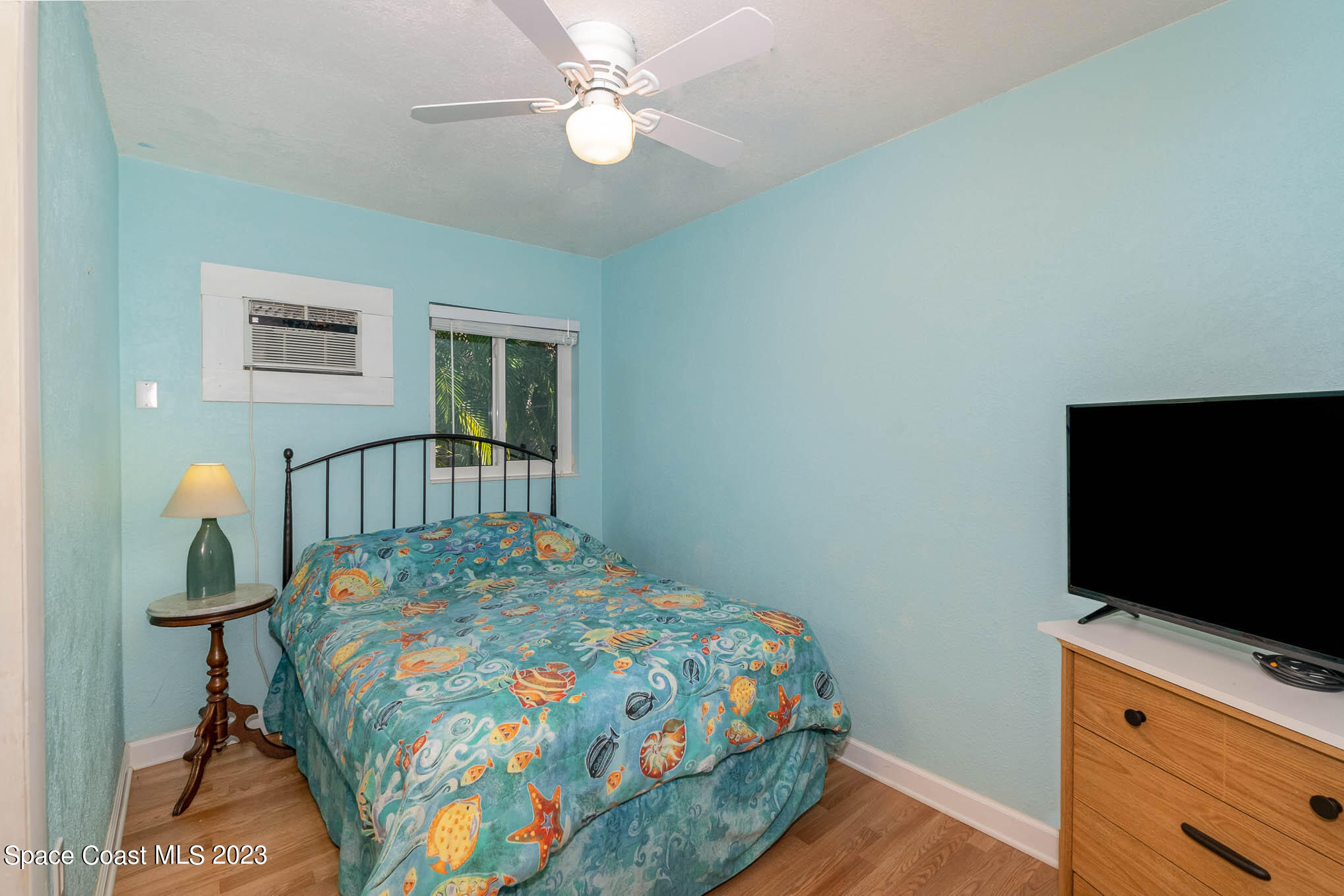 1466 Herndon Circle Palm Bay, FL 32905 - Photo 22 of 23 a bedroom with a bed and a flat screen tv