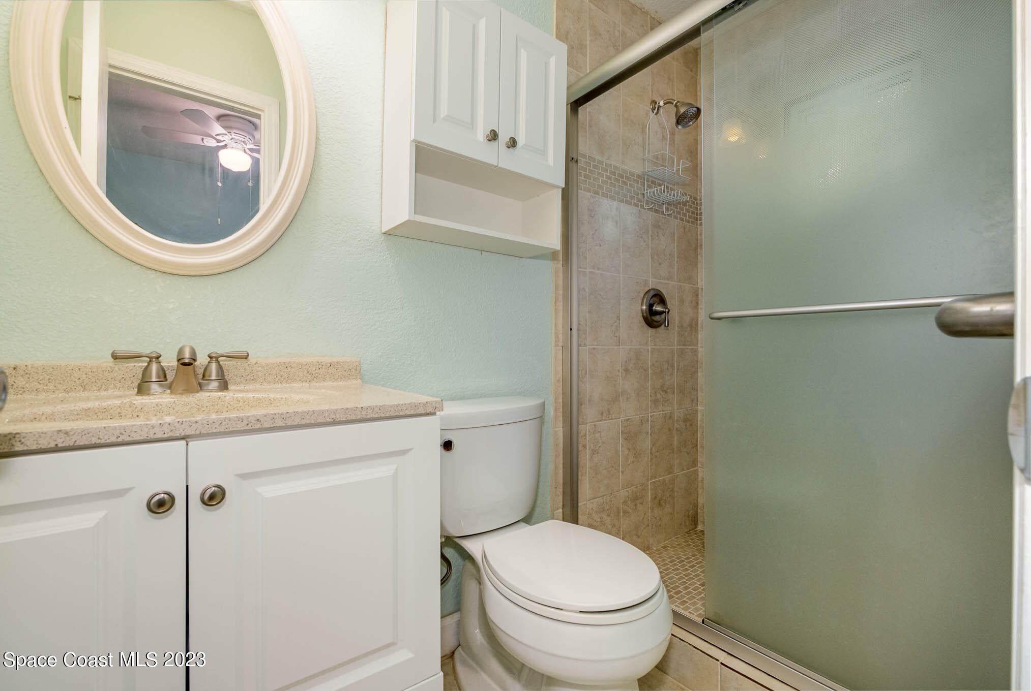 1466 Herndon Circle Palm Bay, FL 32905 - Photo 23 of 23 a bathroom with a granite countertop toilet sink and mirror