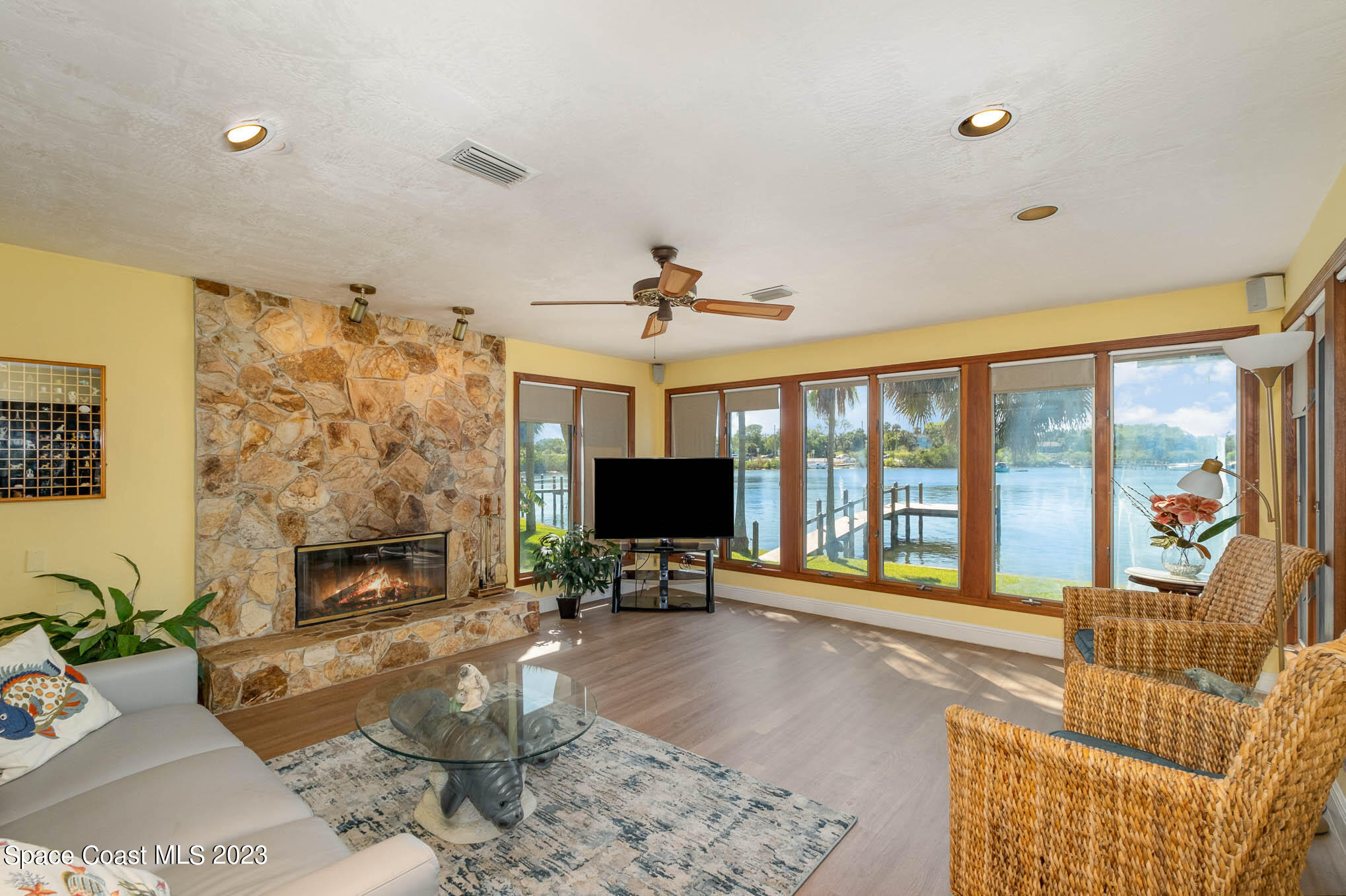 1466 Herndon Circle Palm Bay, FL 32905 - Photo 7 of 23 a living room with furniture large windows and a fireplace