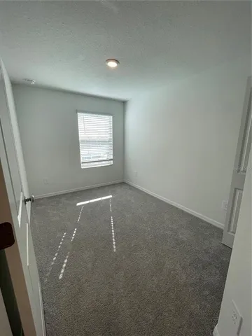 a view of an empty room and closet area