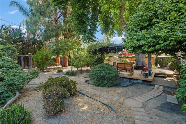 a view of a patio with table and chairs and potted plants