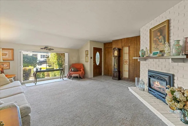 a view of a livingroom with a fireplace and a couch