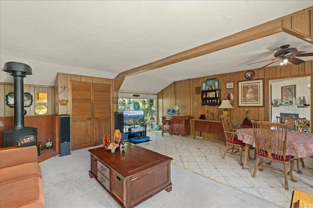 a living room with furniture a rug and a chandelier
