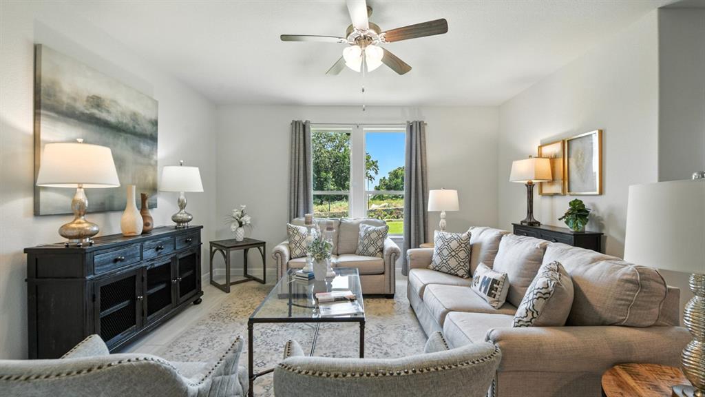 557 Pendleton Avenue Keene, TX 76059 - Photo 10 of 32 a living room with furniture and a chandelier