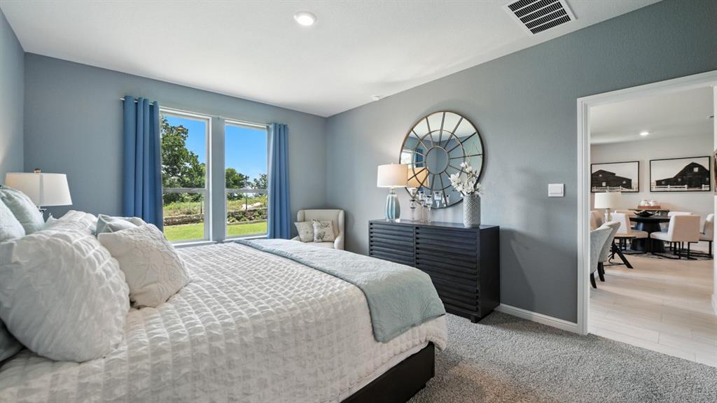 557 Pendleton Avenue Keene, TX 76059 - Photo 13 of 32 a bedroom with a bed and a large mirror on the dresser