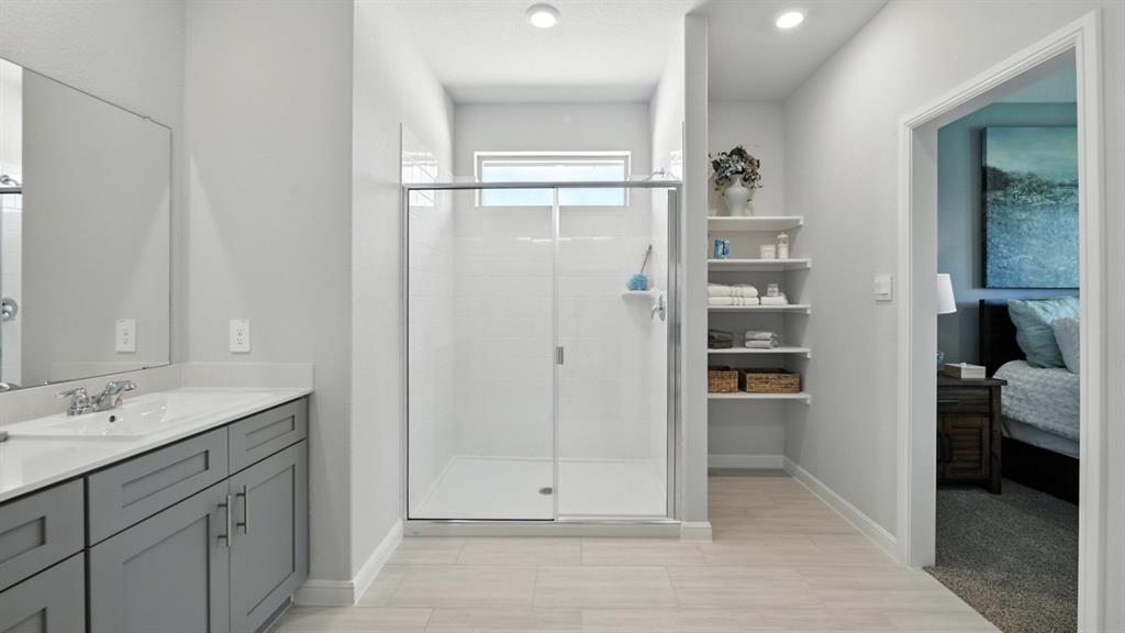 557 Pendleton Avenue Keene, TX 76059 - Photo 15 of 32 a bathroom with a shower sink and mirror