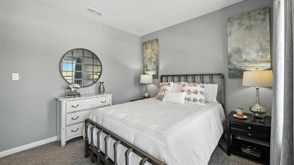 557 Pendleton Avenue Keene, TX 76059 - Photo 18 of 32 a bedroom with a bed and wooden floor