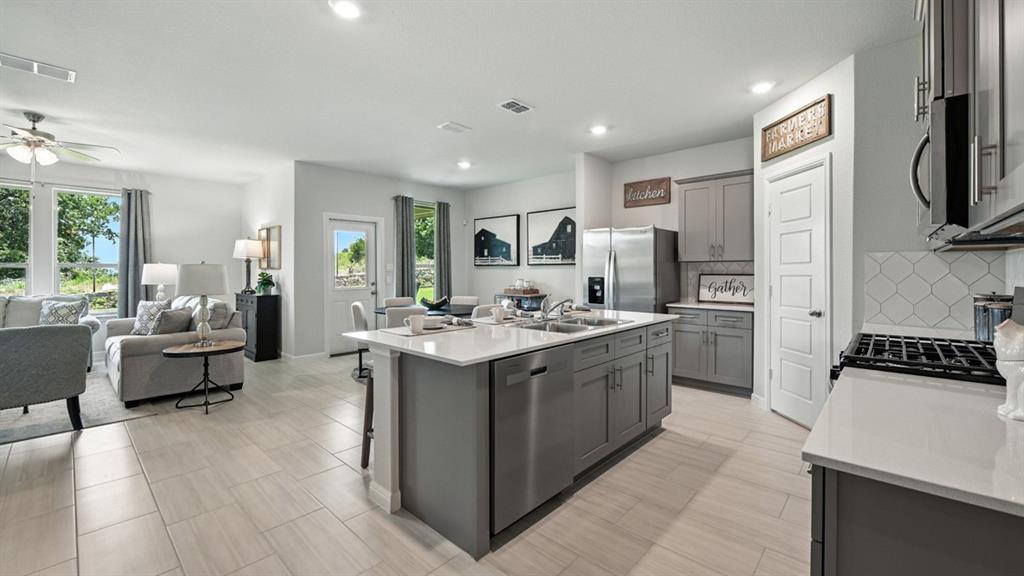 557 Pendleton Avenue Keene, TX 76059 - Photo 2 of 32 a kitchen with a sink stove and refrigerator