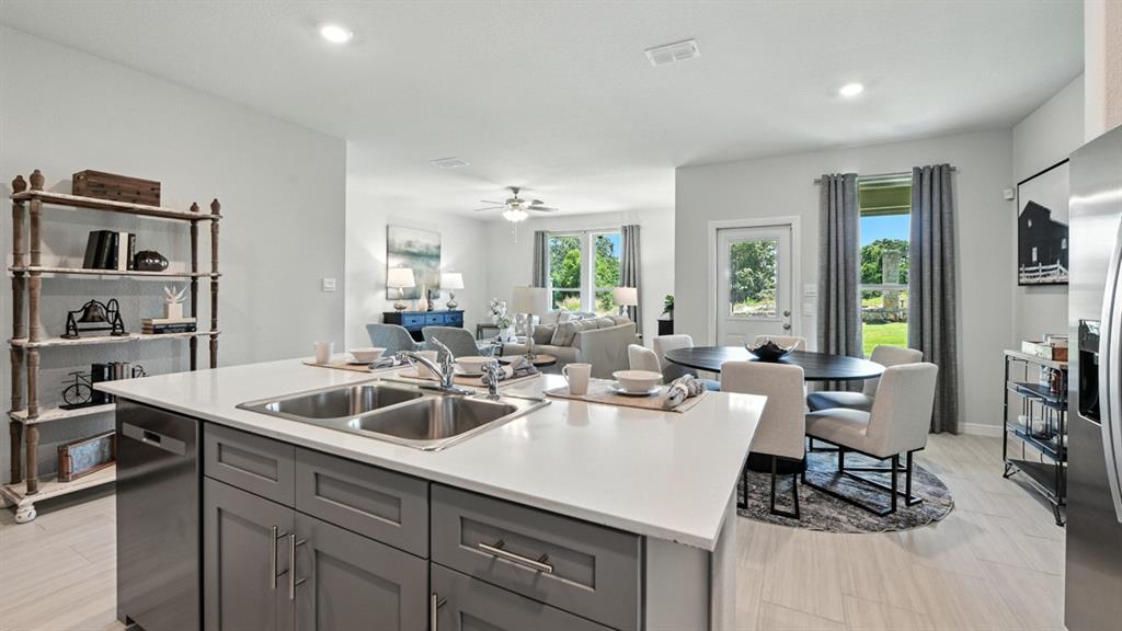 557 Pendleton Avenue Keene, TX 76059 - Photo 4 of 32 a kitchen with a sink and chairs