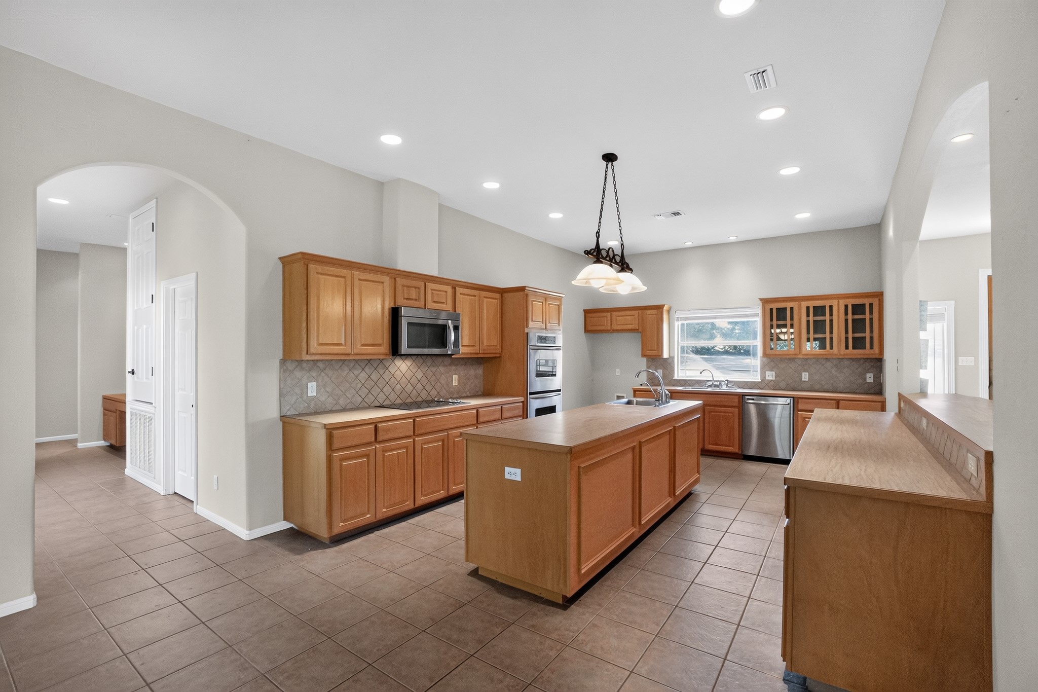 986 High Grove Road Cedar Creek, TX 78612 - Photo 16 of 30 Ample wooden cabinetry and durable tile flooring define this highly functional culinary space.