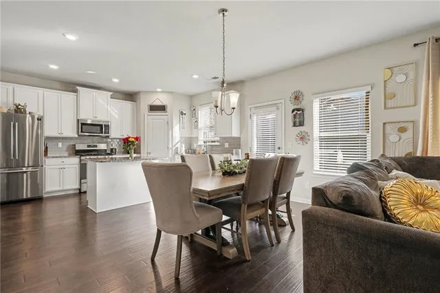 a dining room with furniture and wooden floor