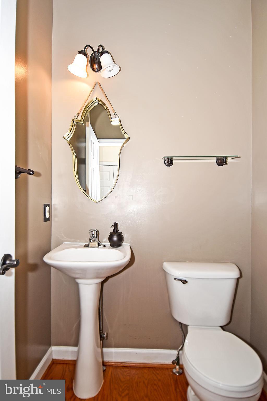14102 Punch Street Silver Spring, MD 20906 - Photo 13 of 30 a bathroom with a toilet a sink and mirror