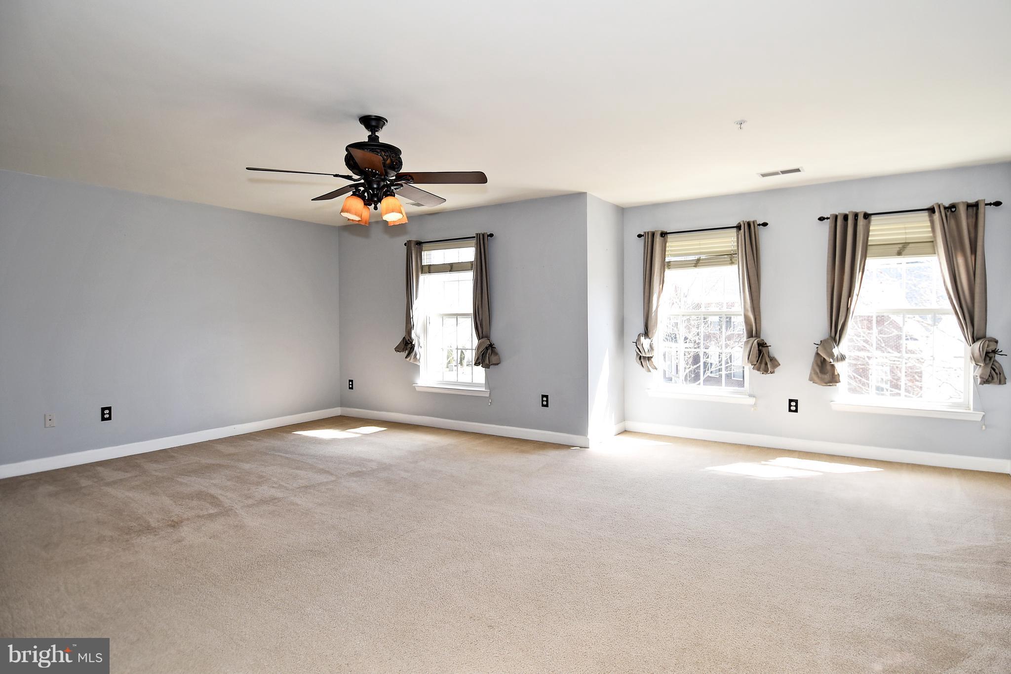 14102 Punch Street Silver Spring, MD 20906 - Photo 17 of 30 an empty room with windows and chandelier fan