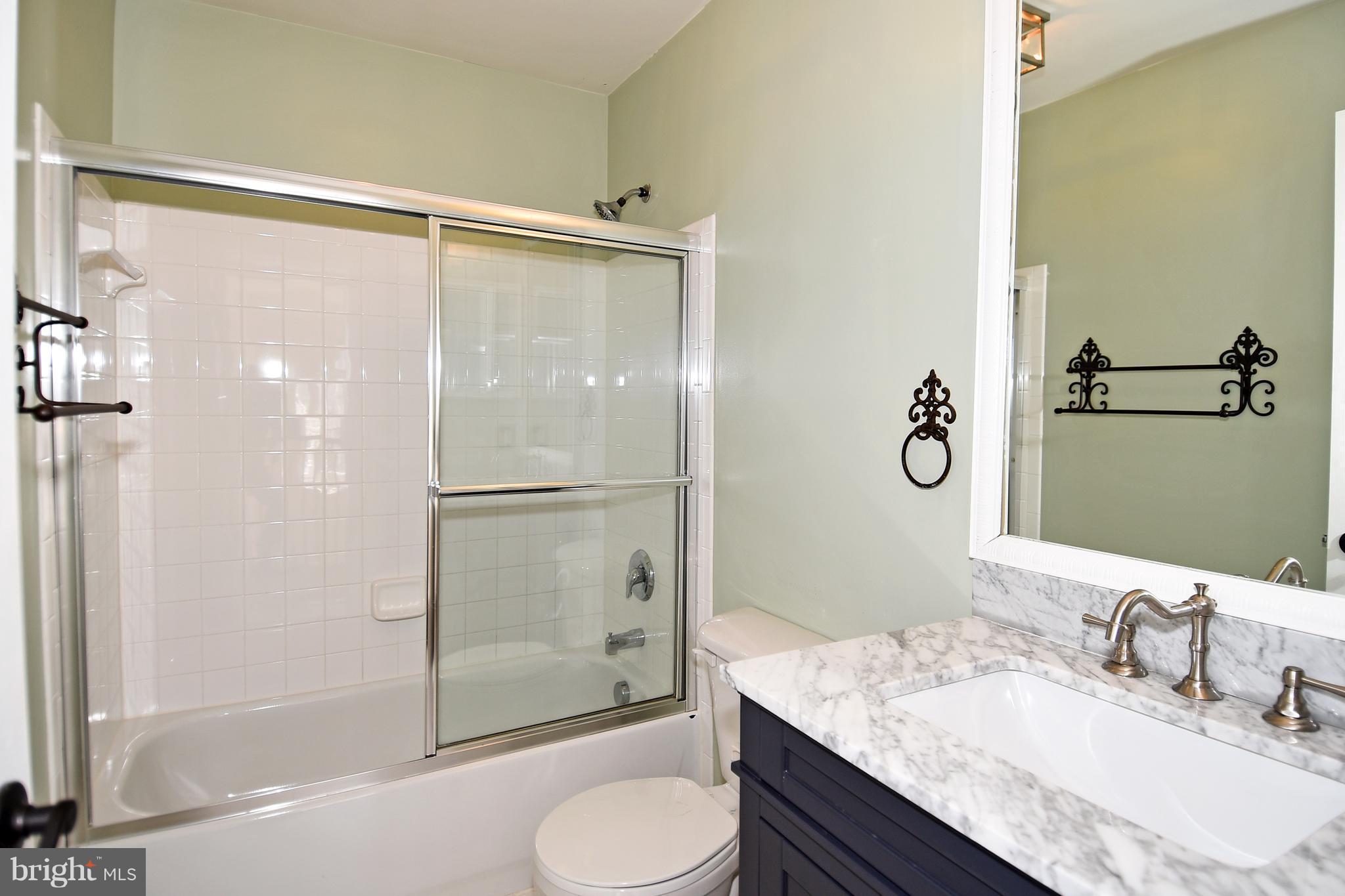 14102 Punch Street Silver Spring, MD 20906 - Photo 22 of 30 a bathroom with a granite countertop sink toilet and shower