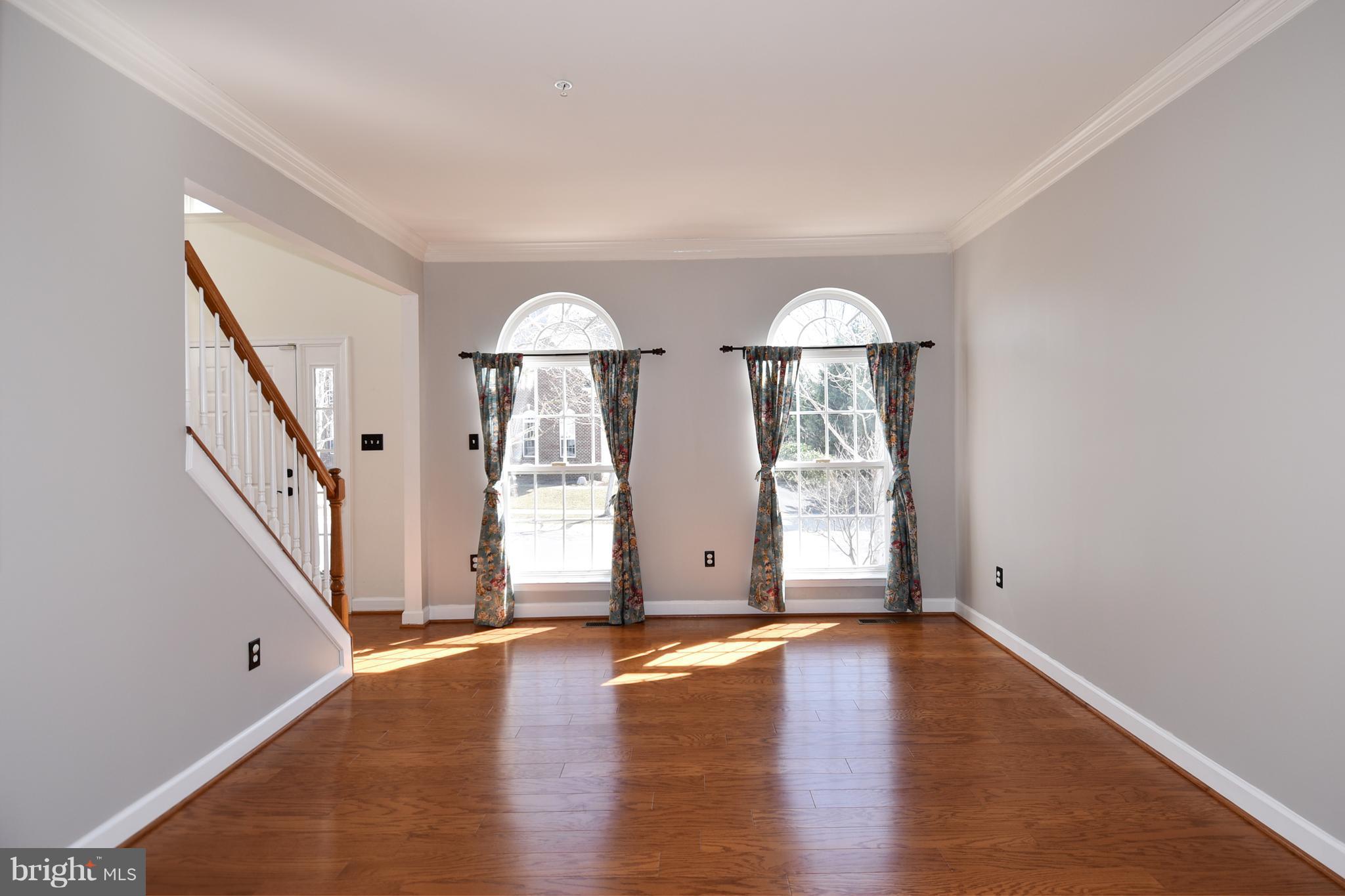 14102 Punch Street Silver Spring, MD 20906 - Photo 4 of 30 an empty room with wooden floor and windows