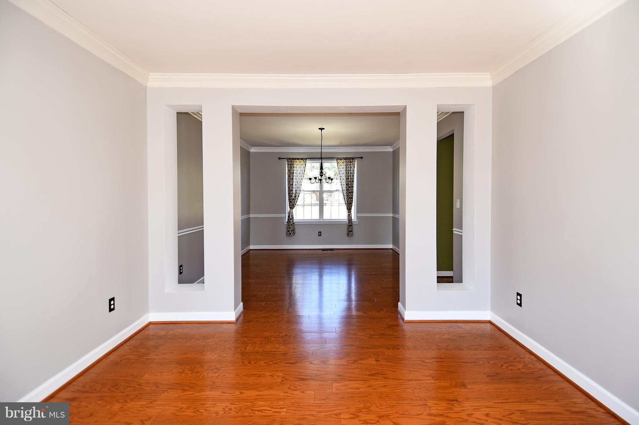 14102 Punch Street Silver Spring, MD 20906 - Photo 5 of 30 a view of an empty room with window and wooden floor