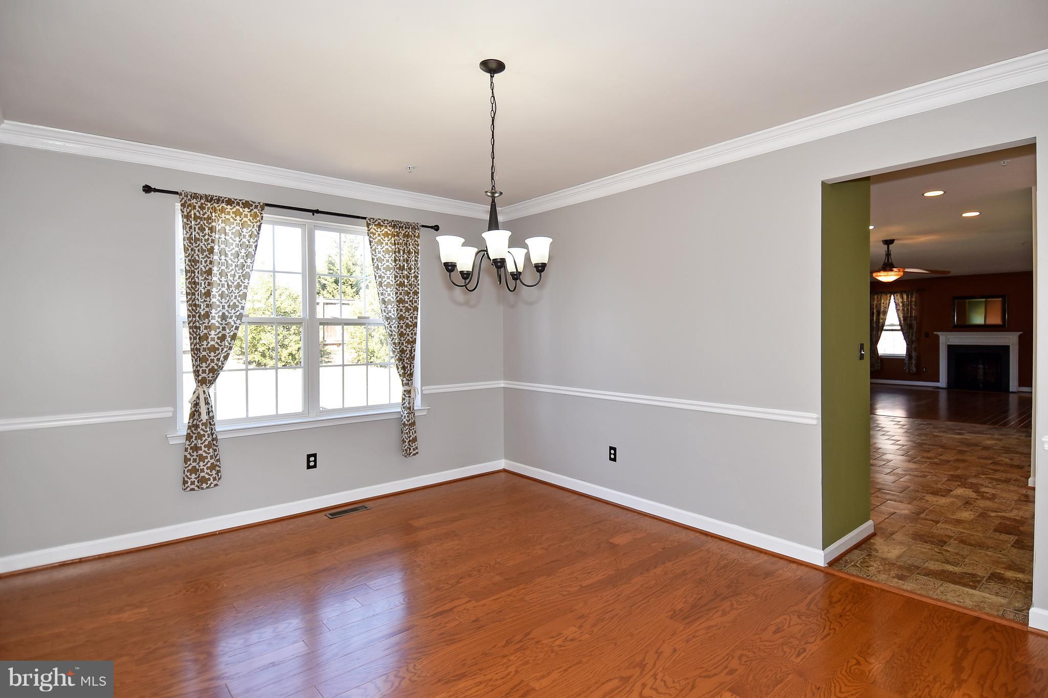 14102 Punch Street Silver Spring, MD 20906 - Photo 6 of 30 a view of a room with window wooden floor and chandelier