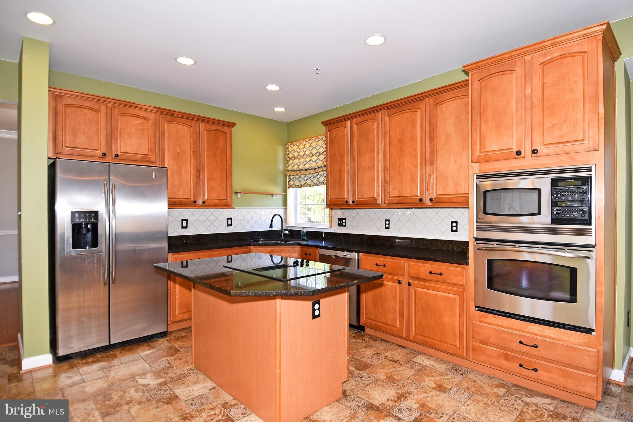 14102 Punch Street Silver Spring, MD 20906 - Photo 8 of 30 a kitchen with stainless steel appliances granite countertop a sink stove refrigerator and cabinets
