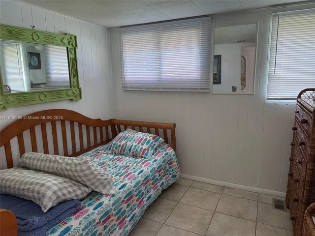 a bedroom with a bed and a mirror