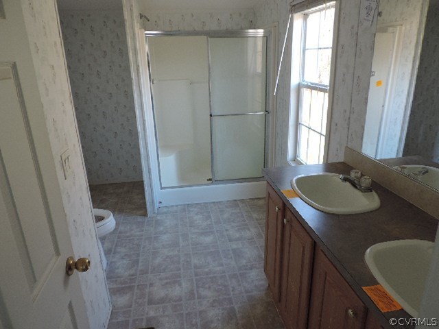 2516 Sneads Store Road Kenbridge, VA 23944 - Photo 13 of 18 a bathroom with a sink toilet and window