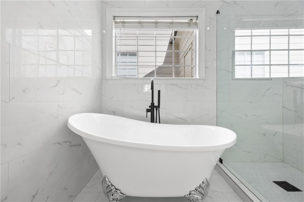 1644 Donovan's Ridge Kennesaw, GA 30152 - Photo 11 of 37 a white bath tub sitting in a bathroom next to a window