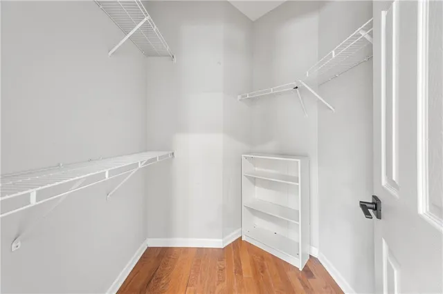 a view of walk in closet with empty racks