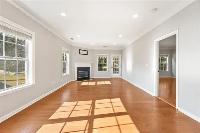 a view of empty room with windows and fireplace