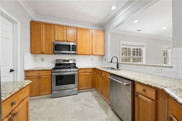a kitchen with granite countertop a sink and a stove top oven