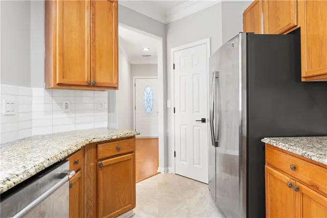 storage and utility room with granite countertop cabinets