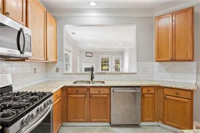 a kitchen with granite countertop wooden cabinets and a stove top oven