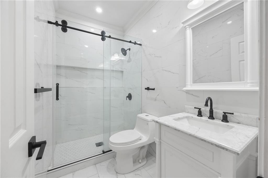 1644 Donovan's Ridge Kennesaw, GA 30152 - Photo 20 of 37 a bathroom with a sink a toilet and shower