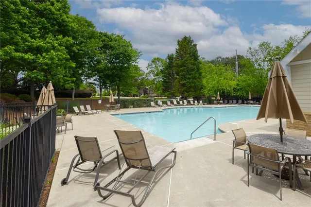 a view of a lake with table and chairs