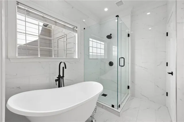 a bathroom with a tub and a shower