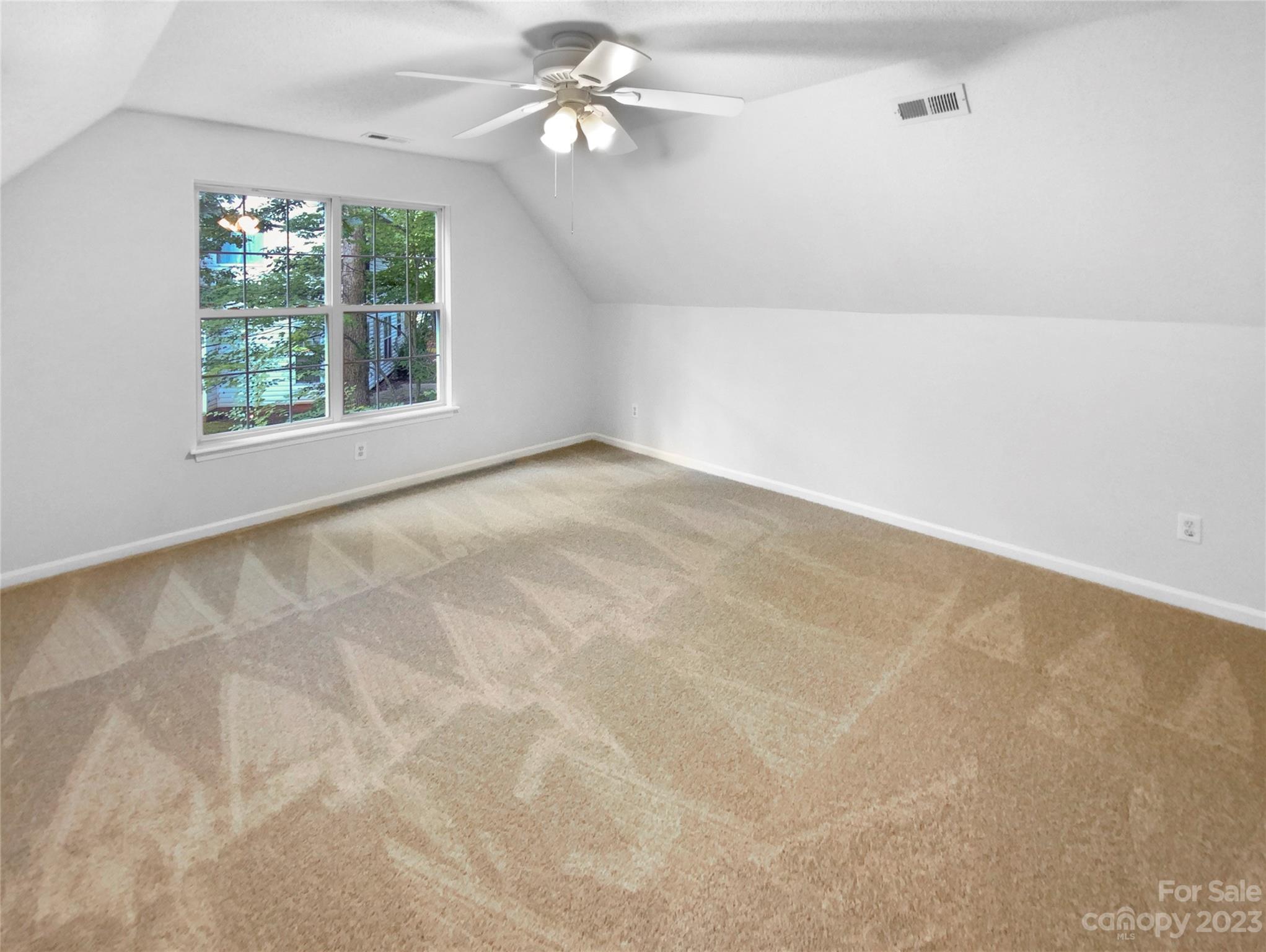 114 Shade Tree Circle Fort Mill, SC 29715 - Photo 17 of 20 an empty room with windows and chandelier fan