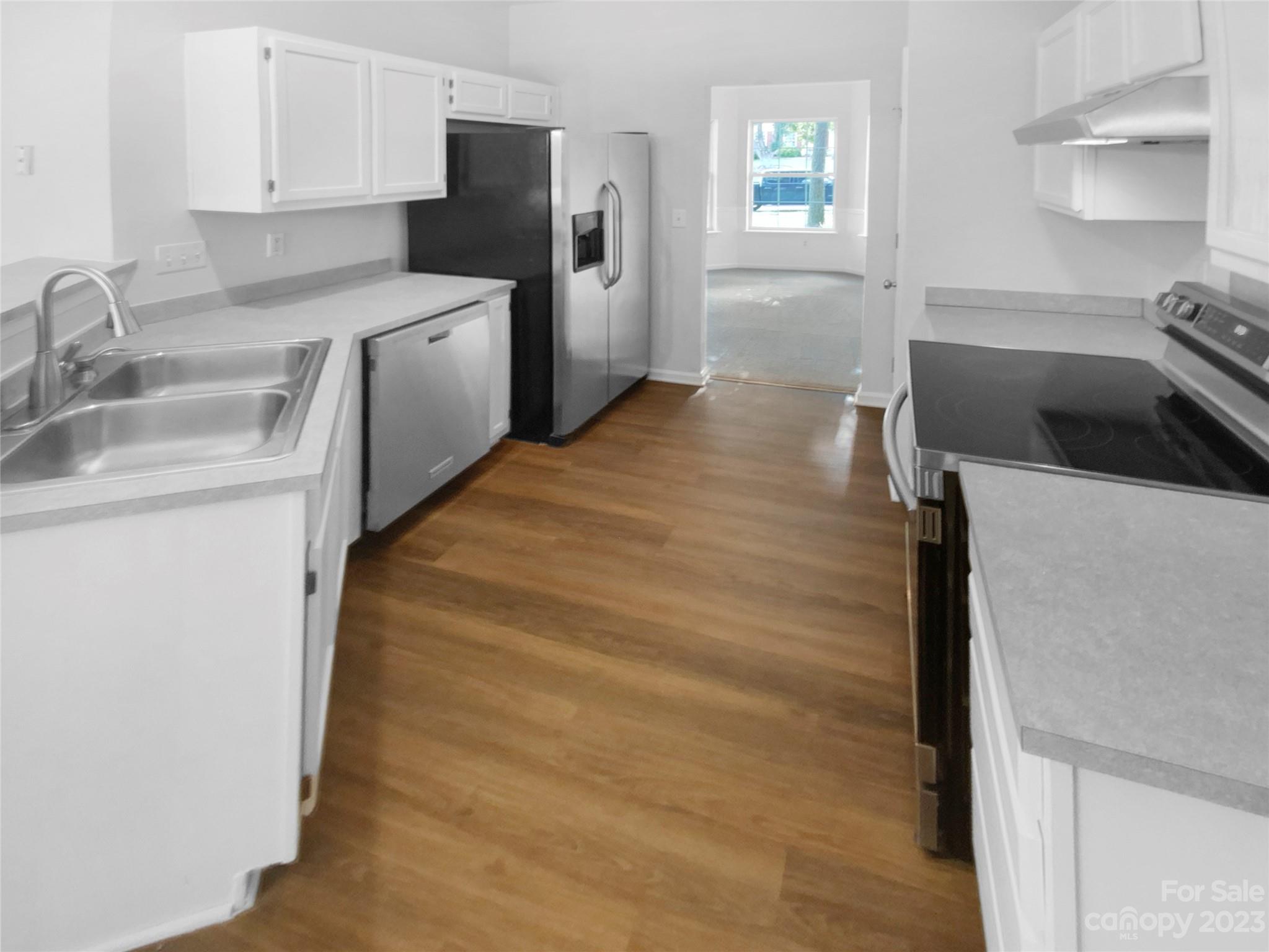 114 Shade Tree Circle Fort Mill, SC 29715 - Photo 6 of 20 a kitchen with a sink a stove and refrigerator