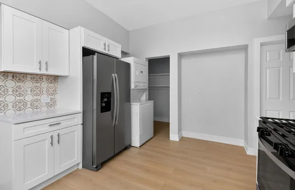 a kitchen with stainless steel appliances a refrigerator and cabinets