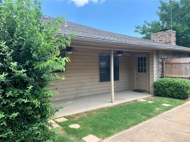 a view of a house with a yard and plants