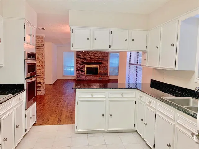 a kitchen with cabinets appliances and a counter space